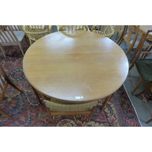 91 - A McIntosh teak extending dining table and four chairs