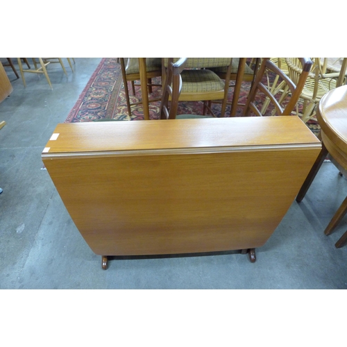 92 - A teak drop leaf table and three chairs