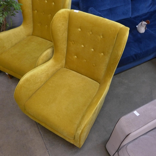 1345 - A mustard yellow button backed armchair