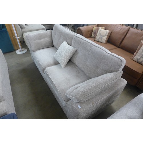 1440 - A grey upholstered pinched back three seater sofa