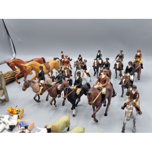 677 - A large collection of Britains lead hunting figures, some similar plastic and diorama accessories