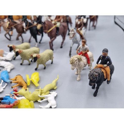 677 - A large collection of Britains lead hunting figures, some similar plastic and diorama accessories