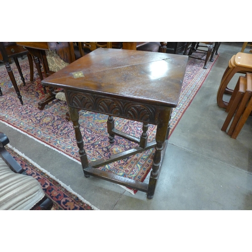 83 - A 17th Century style carved oak fold over corner table