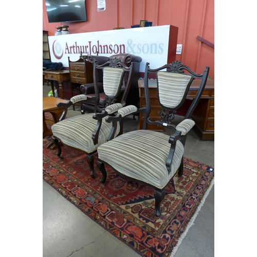 86 - A pair of Edward VII carved mahogany and fabric upholstered open armchairs