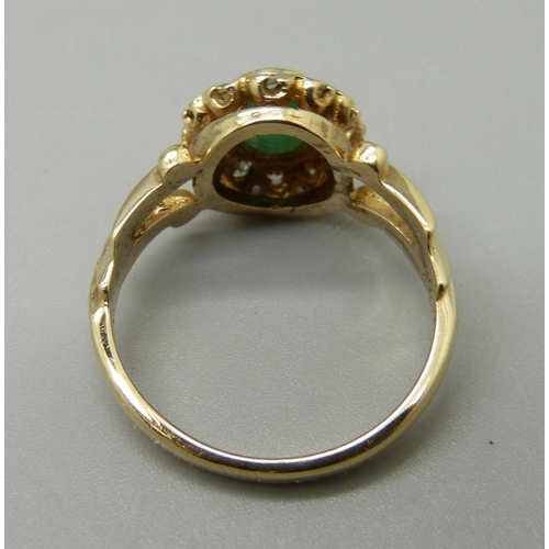 1005 - A 9ct gold, emerald and diamond cluster ring, 3.4g, M