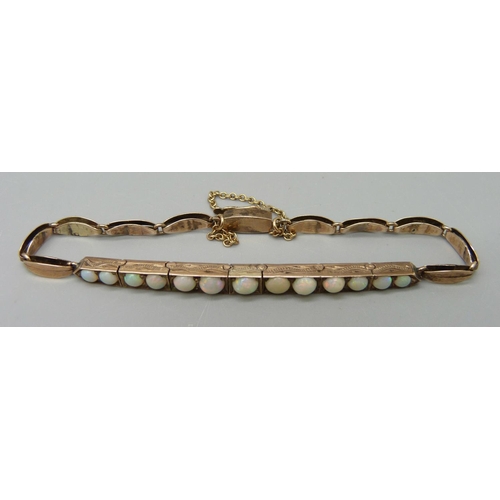 1024 - A yellow metal and opal bracelet, (tests as 9ct gold), 6.4g