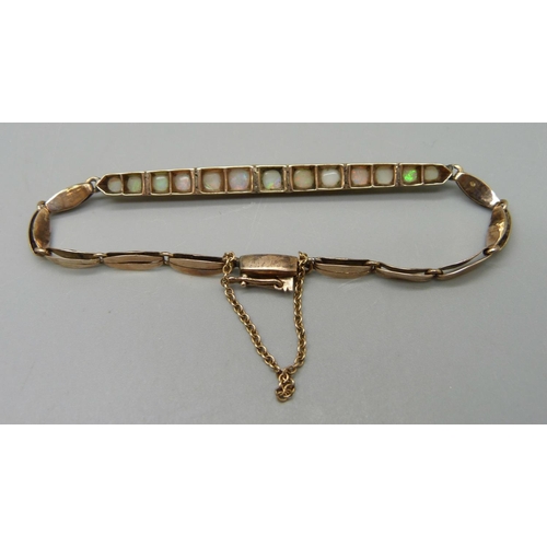 1024 - A yellow metal and opal bracelet, (tests as 9ct gold), 6.4g