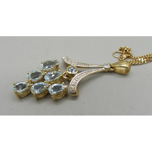 1070 - A 9ct gold, diamond and aquamarine pendant, on a fine 9ct gold chain, 5.3g