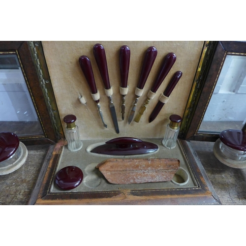 775 - A Victorian manicure case/cabinet with contents (lacking scissors), with bevelled glass panels and m... 