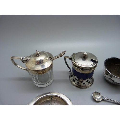 839 - A silver strainer and salt, 70g, a silver mounted mustard, a plate and blue glass mustard and a a pa... 