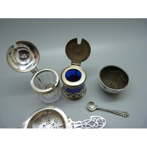 839 - A silver strainer and salt, 70g, a silver mounted mustard, a plate and blue glass mustard and a a pa... 