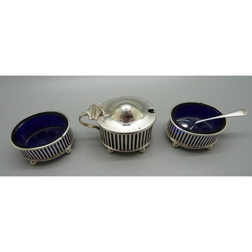 842 - A three piece silver cruet set, London 1909, and a silver spoon, 97g