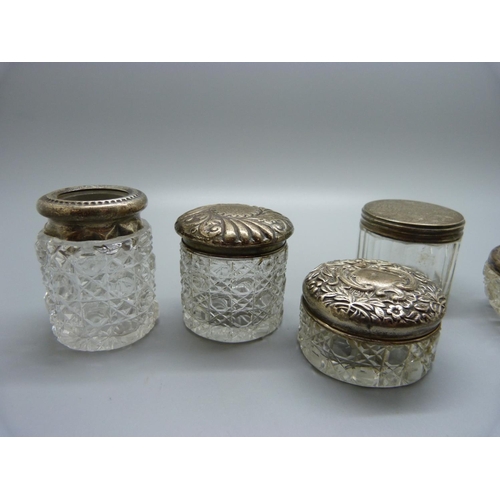 850 - Five glass and silver topped jars