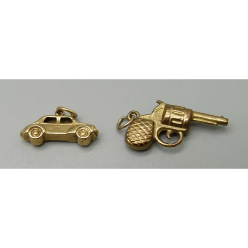 973 - A 9ct gold revolver charm and a 9ct gold car charm, 1.7g