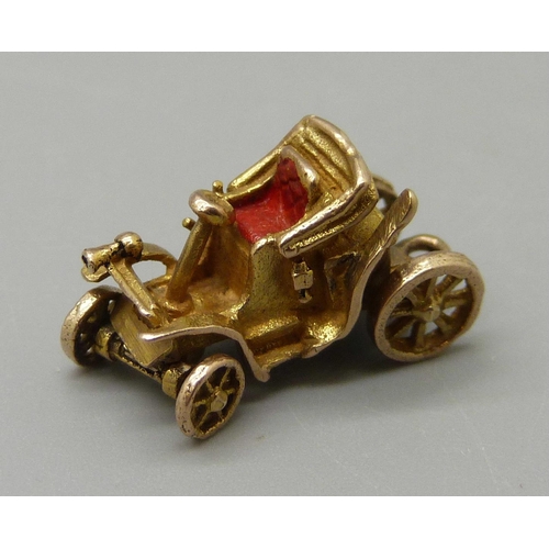 974 - A 9ct gold vintage car charm, with moveable wheels, 2.5g