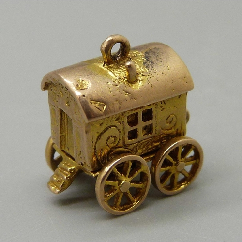 979 - A 9ct gold Romany fortune teller's caravan charm, bottom opens to reveal fortune teller with a cryst... 