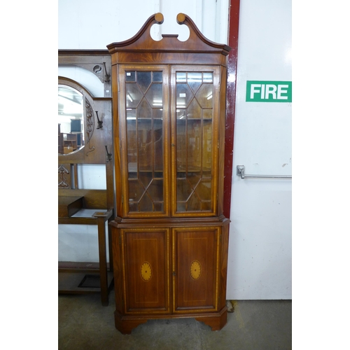 119 - An Edward VII style inlaid mahogany free standing corner cabinet