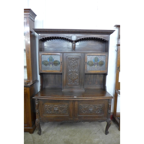 121 - An early 20th century carved oak  Greenman dresser