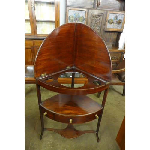 124 - A George III mahogany folding corner washstand