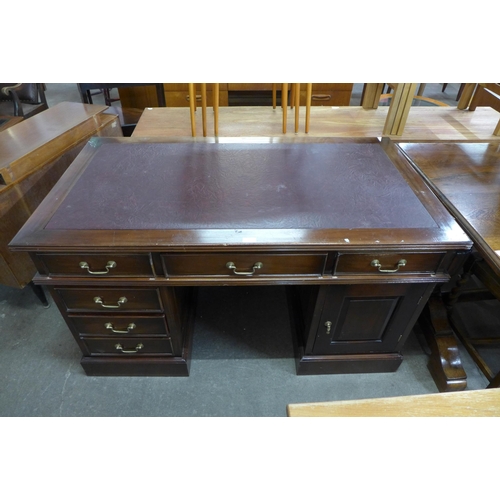 127 - A mahogany and leather topped desk