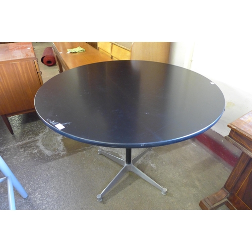 150 - An Eames style circular black and steel based kitchen table