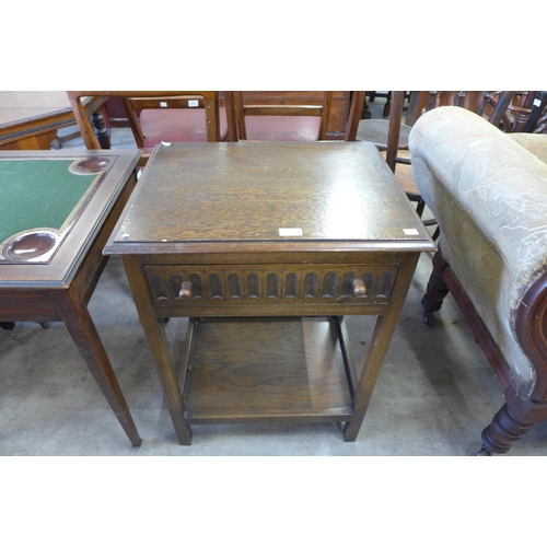 156 - A carved oak single drawer side table