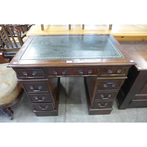 158 - A mahogany and green leather topped pedestal desk