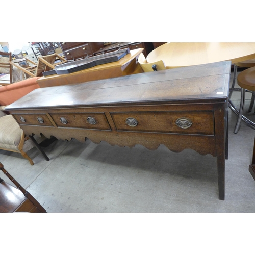 164 - A George III oak three drawer dresser