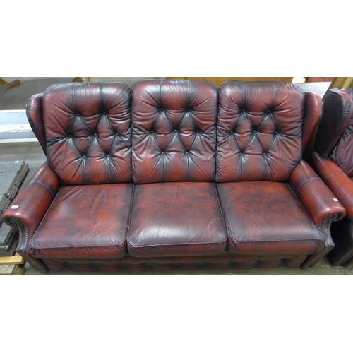 207 - A red leather buttoned sofa and armchair