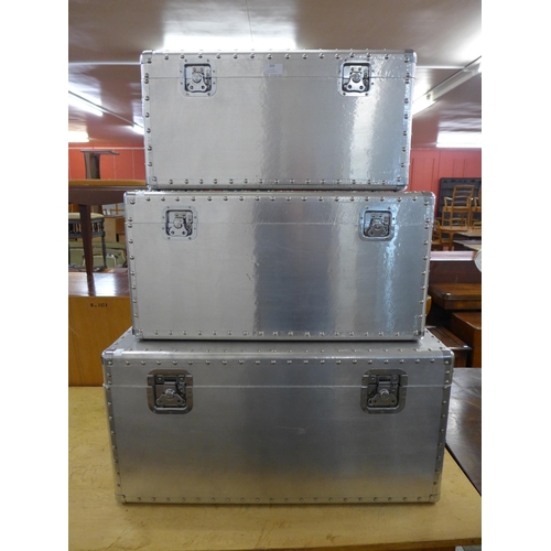 209 - A set of three graduated aluminium travel trunks