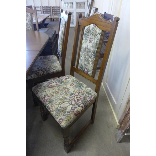 218 - An Old Charm oak extending dining table and six chairs