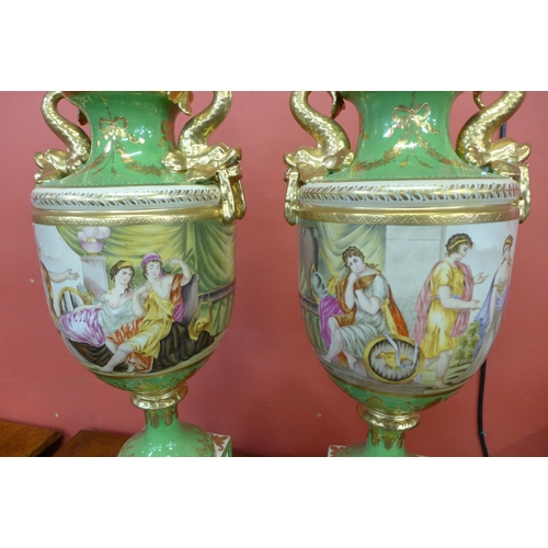 93 - A pair of Italian style green porcelain and gilt vases and covers, decorated with romantic scenes