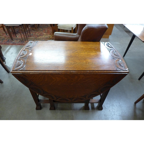 99 - A carved oak gateleg table