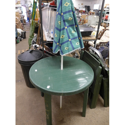 2071 - A green plastic patio table with two chairs and a parasol