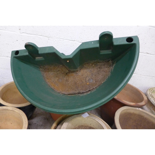 2331 - 2 Green plastic round planters with terracotta planter