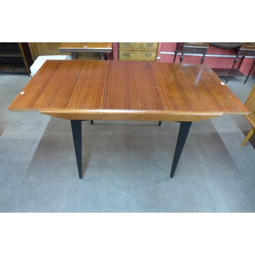 41 - A tola wood and black extending dining table