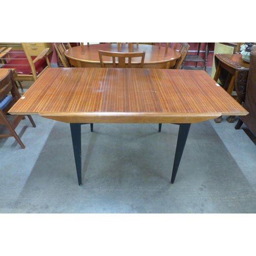 41 - A tola wood and black extending dining table