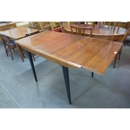 41 - A tola wood and black extending dining table