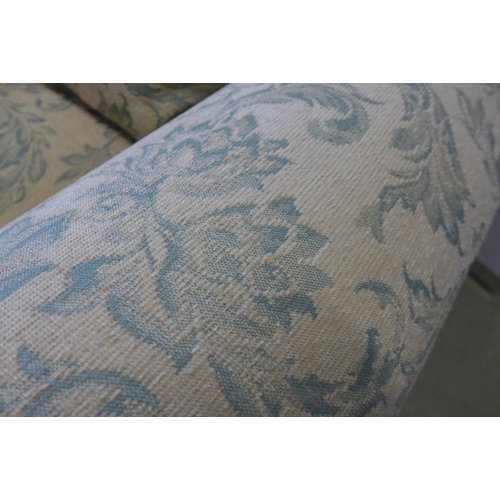 1672 - A magnolia and teal floral upholstered two and three seater sofas