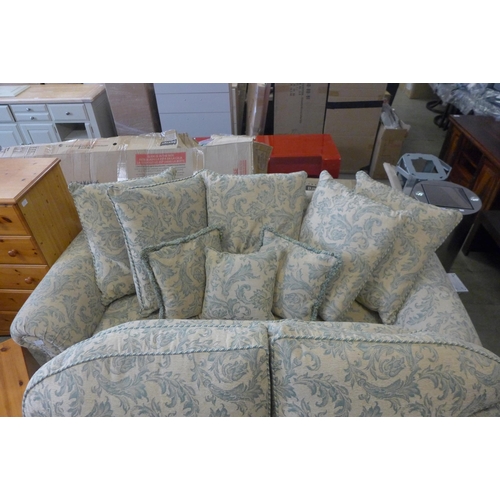 1672 - A magnolia and teal floral upholstered two and three seater sofas