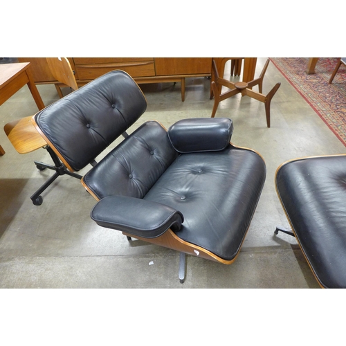 17 - A Ray and Charles Eames style black leather lounge chair and stool, a/f