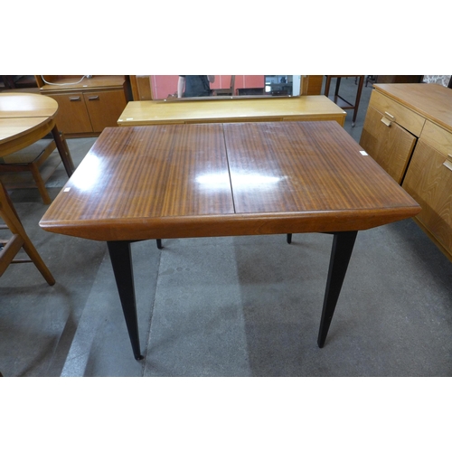 41 - A tola wood and black extending dining table