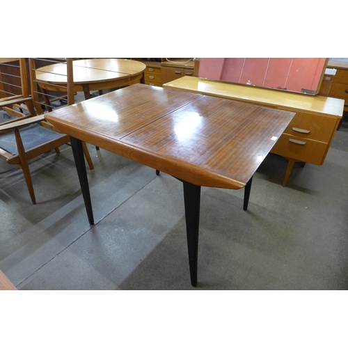 41 - A tola wood and black extending dining table