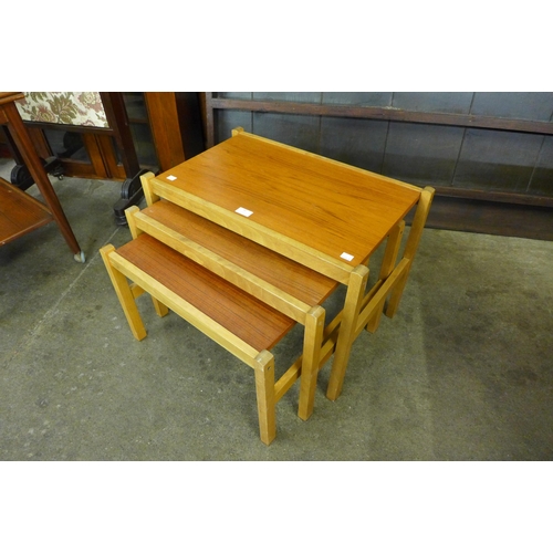 58 - A teak and beech nest of tables