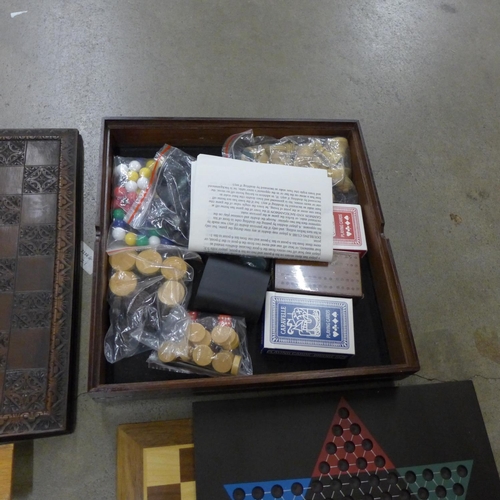 1043 - A collection of board games including chess sets, dominoes and playing cards