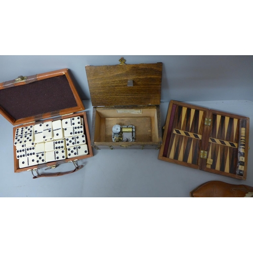 711 - Travel dominoes, a musical box, travel backgammon and a small pair of leather cowboy boots