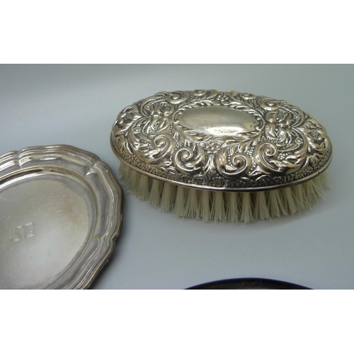 812 - A silver backed brush, a silver topped jar, top a/f, an ebony and applied silver mirror and letter o... 