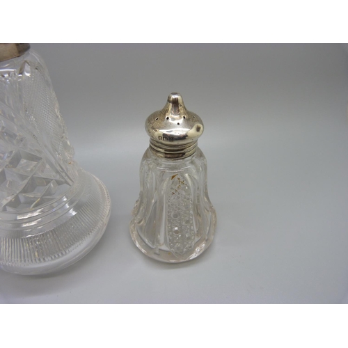 816 - A silver topped glass shaker and a silver topped glass pepper, (pepper top dented)