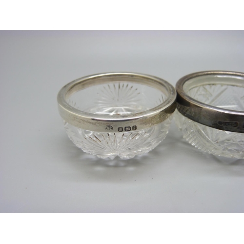 817 - A pair of silver rimmed glass salts and one other