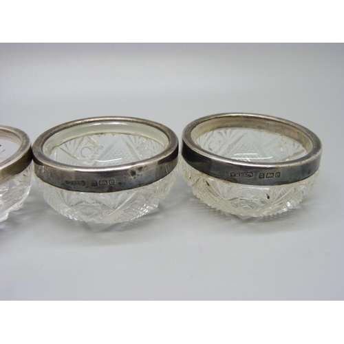 817 - A pair of silver rimmed glass salts and one other